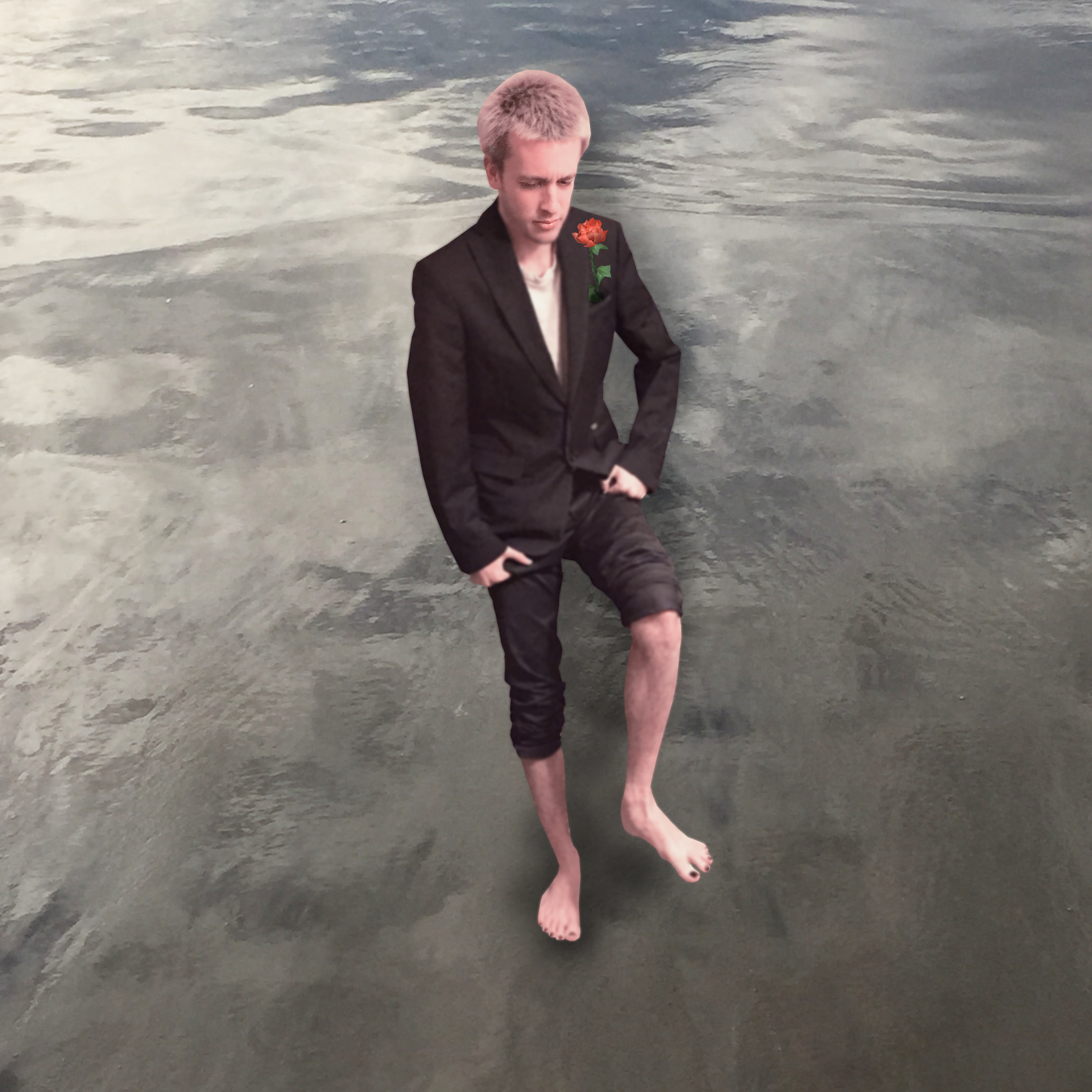 Butler walking barefoot on wet sand while looking at the ground